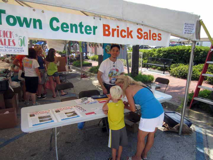 Perennial volunteer selling bricks at Dancin' in the Streets